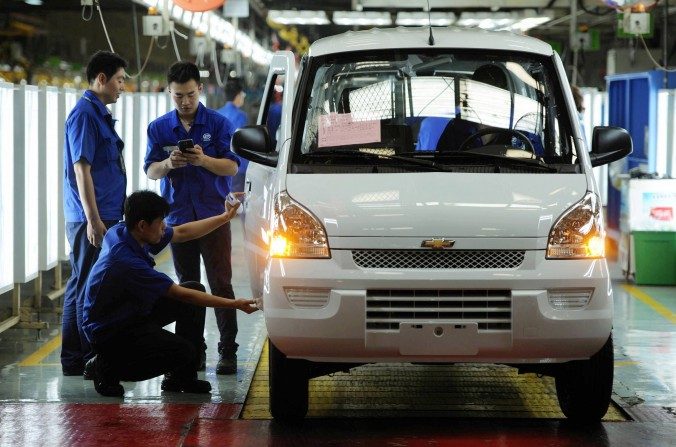 Des ouvriers assemblent des pièces automobiles dans une usine à Qingdao, province du Shandong, le 15 juillet 2015. Les entreprises chinoises ont du mal à rester compétitives avec des produits de mauvaise qualité. (STR / AFP / Getty Images)