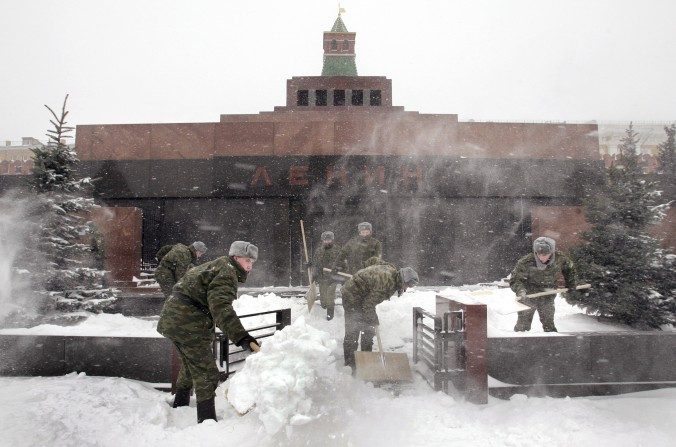 Les soldats russes défrichent  la neige devant le Mausolée de Vladimir Ilitch Lénine, ancien leadeur communiste russe, le 28 janvier 2005. Près d'un siècle après la mort de Lénine, son corps embaumé se trouve dans le Mausolée à  Place Rouge de Moscou. (YURI KADOBNOV / AFP / Getty Images)