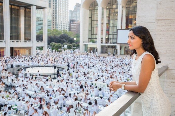 Le 22 août 201, une femme comtemple la place Josie Robertson au Lincoln Center, où environ 5 000 personnes assistent au Diner en Blanc. Les invités s'habillent uniquement en blanc et apportent leur propre pique-nique et tables blanches à New York. (Eric Vitale pour Dîner en Blanc)