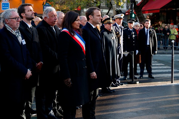 Le président français Emmanuel Macron (C), le maire de Paris Anne Hidalgo (4e), le président du Sénat français, Gérard Larcher (3e L), le vice-maire de Paris Bruno Julliard (2e) et le préfet de police de Paris Michel Delpuech (4e) observent une minute silence après avoir déposé une gerbe de fleurs devant une plaque commémorative à côté du café «À La Bonne Bière» et de la rue de la Fontaine au Roi lors d'une cérémonie le 13 novembre 2017, marquant le deuxième anniversaire des attentats djihadistes coordonnés  à Paris qui ont fait 130 morts et plus de 350 blessés. 
(PHILIPPE WOJAZER / AFP / Getty Images)