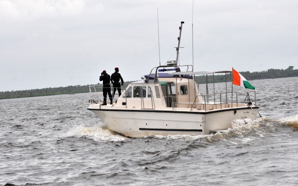 -Des garde-côtes montent la garde dans un bateau lors d’une patrouille au port. Le port d’Abidjan a acquis deux nouveaux bateaux pour aider ses garde-côtes à dissuader les menaces potentielles des pirates. Photo : SIA KAMBOU / AFP / Getty Images.