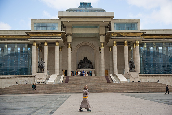 Un homme mongol vêtu de façon traditionnelle s'entretient sur un téléphone portable devant une statue de Chinggis Khan (Gengis Khan) le 11 juin 2015 à Oulan-Bator, en Mongolie. (Photo : Taylor Weidman/Getty Images)