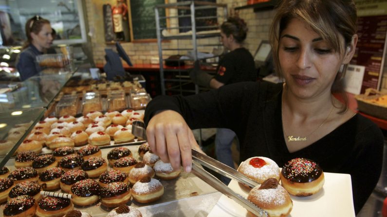 -Le 6 décembre. Une serveuse israélienne, prépare une portion de beignets frits à l'huile et remplis de confiture, appelés sufganiyot en hébreu. Dans la tradition juive, il est de coutume de manger les beignets et autres aliments frits à l'huile lors du festival de huit jours d’Hanoukka. Aussi connue sous le nom de Fête des Lumières, Hanoukka commémore la réinauguration du temple juif de Jérusalem 165 ans av. J.-C. Il n'y avait que suffisamment d'huile d'olive consacrée pour alimenter la flamme éternelle dans le temple, miraculeusement l'huile a brûlé pendant huit jours. Photo de David Silverman / Getty Images.