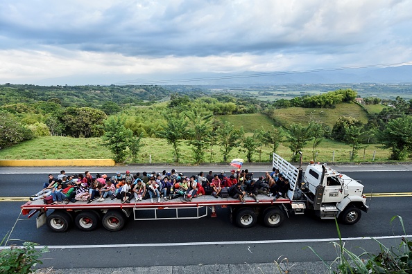 -Le 14 janvier 2019, un migrant vénézuélien emprunte un camion sur une route reliant l'Arménie à Cali, en Colombie. Le président vénézuélien, Nicolas Maduro, a prêté serment jeudi pour un second mandat, après avoir remporté une élection anticipée boycottée par l’opposition. Ses détracteurs lui reprochent les difficultés économiques du pays, qui ont laissé des millions de personnes dans la pauvreté, tandis que 2,3 millions supplémentaires, selon les Nations Unies, ont fui le pays depuis 2015. Ceux qui sont encore à la traîne doivent faire face à une pénurie de produits de première nécessité tels que la nourriture et les médicaments. Les services publics sont défaillants tels que l’eau, l’électricité et les transports. Photo de Luis ROBAYO / AFP / Getty Images.