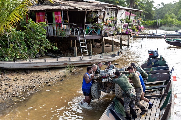 -Des soldats déchargent un quad le 20 janvier 2019 à la base du 9e régiment d'infanterie de marine à Saint-Jean-du-Maroni, en Guyane française, dans le cadre de l'opération Harpie menée par les Forces armées guyanaises et des gendarmes lutter contre l'orpaillage illégal. Photo de Jody AMIET / AFP / Getty Images.