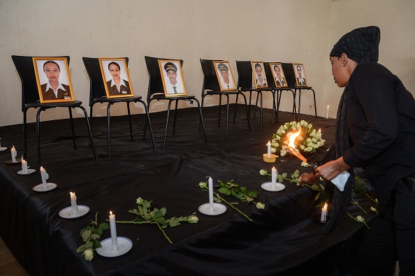 -Une femme offre des fleurs lors d'une cérémonie commémorative en l'honneur des sept membres de l'équipage de la compagnie Ethiopian Airlines, décédée dans l'accident au club de l'association des pilotes éthiopiens à Addis-Abeba le 11 mars 2019.  Photo by - / AFP / Getty Images.