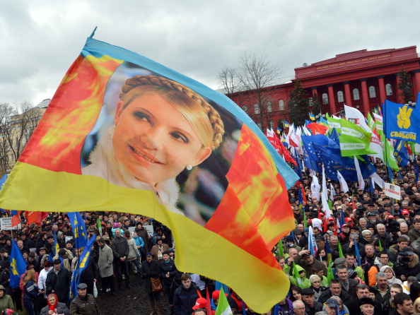 -Les gens agitent un drapeau décrivant l'ancien Premier ministre ukrainien et chef de l'opposition, Ioulia Timochenko, lors d'un rassemblement de l'opposition à Kiev le 7 avril 2013, appelant à la démission du président Viktor Ianoukovitch face aux tensions politiques croissantes. Photo SERGEI SUPINSKY / AFP / Getty Images.