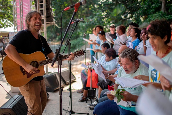 -Le musicien brésilien Ricardo "Rico" Branco de Vasconcelos dirige la chorale "With One Voice" lors de la foire à Rio de Janeiro, au Brésil, le 4 avril 2019. Photo de Mauro PIMENTEL / AFP /Getty Images.