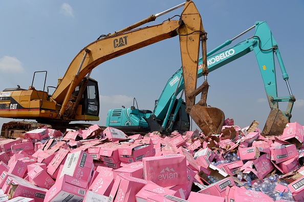 Des médicaments et des bouteilles d'eau d'Evian contrefaits détruits à Phnom Penh le 12 mars 2019. (TANG CHHIN SOTHY/AFP/Getty Images)