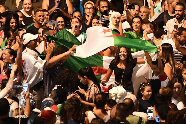 Sur le Vieux-Port de Marseille, des supporteurs de l’Algérie exultent après la qualification de leur équipe face au Nigéria le 14 juillet. Crédit : BORIS HORVAT/AFP/Getty Images.