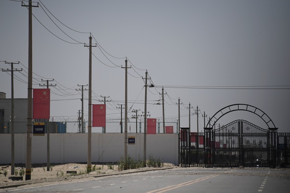 -Cette photo prise le 31 mai 2019 montre des drapeaux chinois sur une route menant à un centre de rééducation où sont généralement détenues des minorités ethniques musulmanes, dans la banlieue de Hotan, dans la région du Xinjiang, au nord-ouest de la Chine. Photo GREG BAKER / AFP via Getty Images.