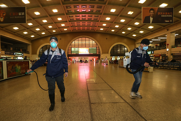 -Des membres du personnel désinfectent à la gare de Hankou à Wuhan, dans la province centrale du Hubei, en Chine, le 22 janvier 2020. La ville chinoise au centre d'une épidémie de virus du type SRAS a exhorté les gens à rester à l'écart, annulant un nouvel an lunaire, un événement majeur, car il s'efforce de contenir une maladie qui s'est propagée déjà à travers le pays. Photo par STR / AFP / China OUT via Getty Images.