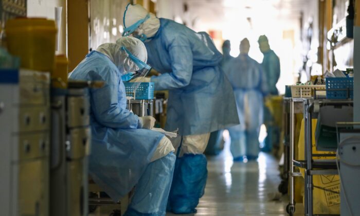 Des membres du personnel médical travaillant dans le service d'isolement de l'hôpital de la Croix-Rouge de Wuhan, dans la province centrale de Hubei, en Chine, le 16 février 2020. (STR/AFP via Getty Images)