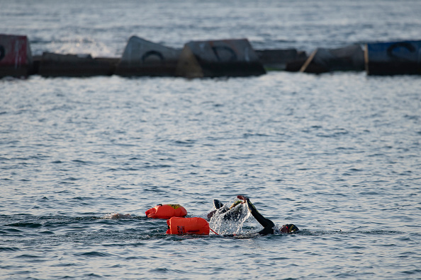 -Deux personnes nagent sur la plage de La Barceloneta à Barcelone, le 8 mai 2020, ouverte pour la première fois depuis que l'Espagne a déclaré l'état d'urgence en raison de la nouvelle épidémie de coronavirus. Photo de Josep LAGO / AFP via Getty Images.