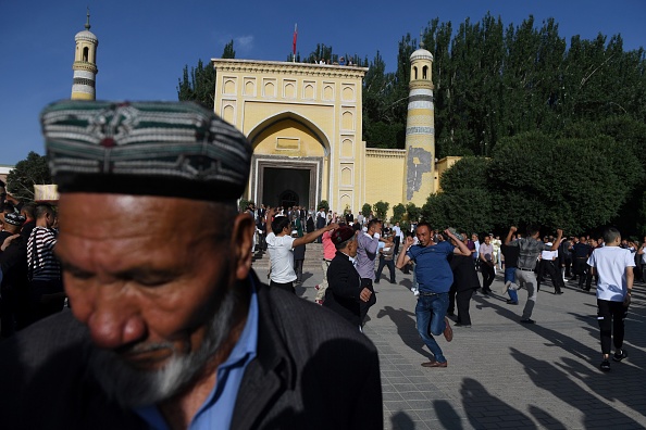 -Des hommes ouïghours dansent après les prières de l'Aïd al-Fitr, marquant la fin du ramadan, à la mosquée Id Kah à Kashgar, dans la région ouest du Xinjiang en Chine, le 5 juin 2019. -Photo GREG BAKER / AFP via Getty Images.