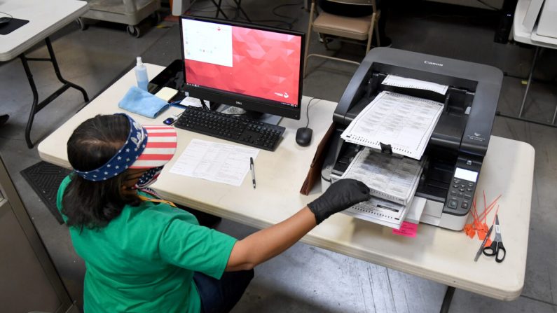 Une employée scanne les bulletins de vote par correspondance au département électoral du comté de Clark à North Las Vegas, le 7 novembre 2020. (Ethan Miller/Getty Images)