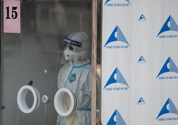 -Un travailleur médical attend dans une station de test du coronavirus Covid-19 à Pékin le 23 janvier 2021. Photo par Noel Celis / AFP via Getty Images.