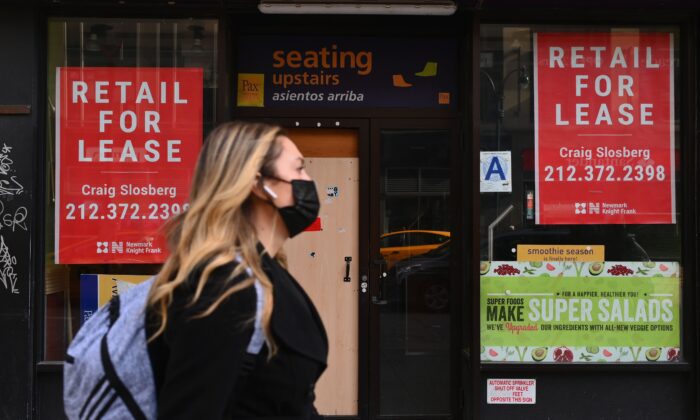 Le 25 janvier 2021, une femme passe devant un magasin de détail fermé à louer dans le centre de Manhattan, à New York. (Angela Weiss/AFP via Getty Images)