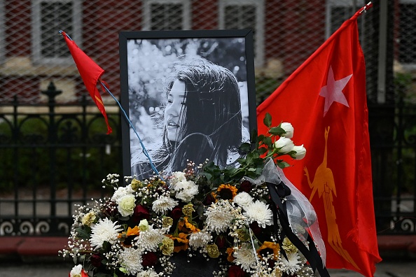 -Des fleurs, un portrait et un drapeau du parti de la Ligue nationale pour la démocratie en l'honneur de Mya Thwate Thwate Khaing, première victime du coup d'État militaire à Yangon le 19 février. 2021. Photo par Ye Aung THU / AFP via Getty Images.