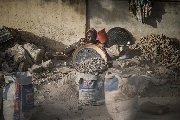 -Habiba, une concasseuse de gravier tamise avec un tamis improvisé pour séparer le gravier du sable à N'Djaména, le 12 avril 2021. Photo by Marco Longari /AFP via Getty Images.