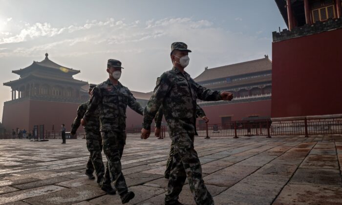 Des soldats de l'Armée populaire de libération chinoise défilent près de la Cité interdite lors de la cérémonie d'ouverture de la Conférence consultative politique du peuple chinois à Pékin, le 21 mai 2020. (Nicolas Asfouri/AFP via Getty Images)
