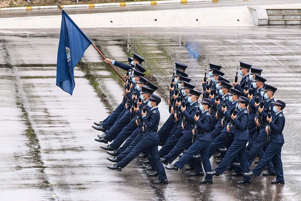 Des policiers effectuent une nouvelle marche au pas de l'oie, du même style utilisé par la police et les troupes sur le continent chinois, à Hong Kong le 15 avril 2021. Photo par Anthony WALLACE / AFP via Getty Images.