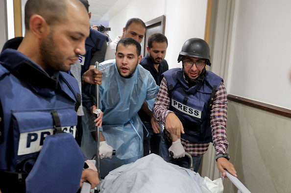 Des journalistes  escortent le corps de la journaliste d'Al-Jazeera Shireen Abu Aqleh, tuée par balle alors qu'elle couvrait un raid dans le camp de réfugiés de Jénine, en Cisjordanie, le 11 mai 2022, à l'hôpital de Jénine.  (Photo :  JAAFAR ASHTIYEH/AFP via Getty Images)