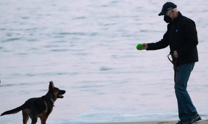 Le président américain Joe Biden et son jeune chien Commander à Rehoboth Beach dans le Delaware, le 28 décembre 2021. (Saul Loeb/AFP via Getty Images)