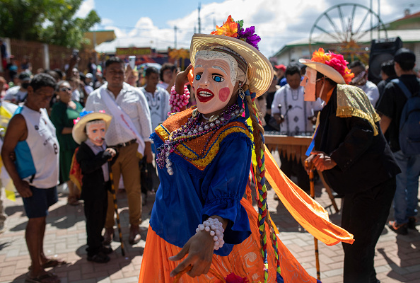 Des danseurs portant des costumes représentant "El Viejo y la Vieja" se produisent devant l'église de Diriamba lors de la fête de la Saint-Sébastien à Diriamba. (Photo STR/AFP via Getty Images)