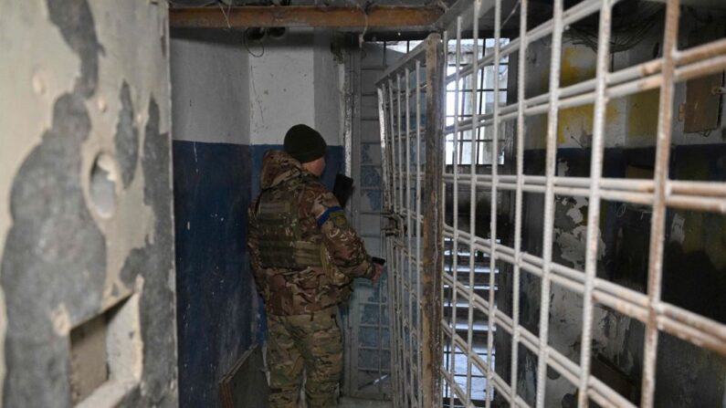 Un policier ukrainien marche dans le sous-sol du quartier général de la police régionale, qui aurait servi de lieu de torture pour les citoyens pro-ukrainiens pendant l'occupation russe, à Kherson, le 31 janvier 2023. (Photo GENYA SAVILOV/AFP via Getty Images)