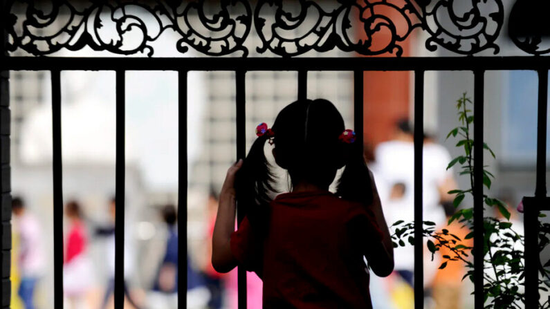 Une jeune fille regarde à travers un portail à Pékin, en Chine, le 19 septembre 2012. (Wang Zhao/AFP/GettyImages)