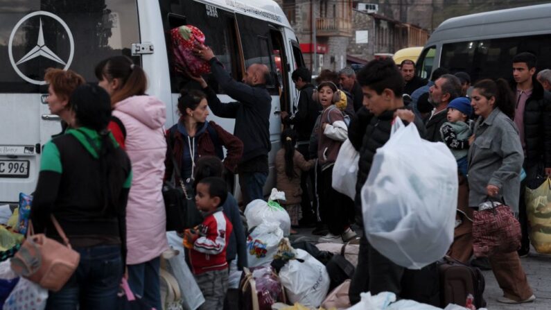 Des réfugiés montent dans un bus près d'un centre d'enregistrement de la Croix-Rouge à Goris, le 27 septembre 2023. (Photo ALAIN JOCARD/AFP via Getty Images)