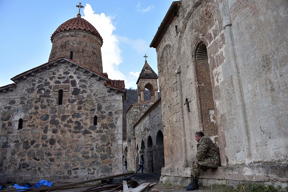 Un soldat arménien est assis sur un mur du monastère orthodoxe Dadivank, en 2020. (Photo KAREN MINASYAN/AFP via Getty Images)