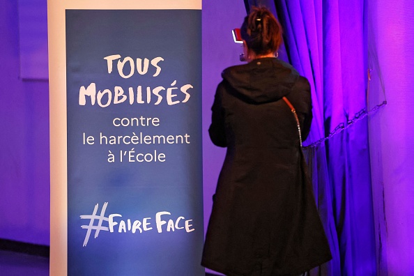 Une personne arrive pour assister à un événement visant à sensibiliser au harcèlement scolaire dans un lycée de Paris, le 7 novembre 2023, deux jours avant une journée nationale contre le harcèlement scolaire. (LUDOVIC MARIN/AFP via Getty Images)