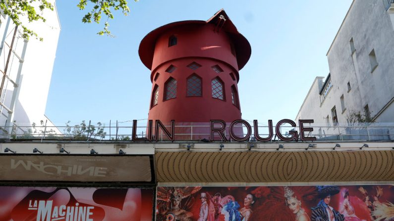 This photograph taken on April 25, 2024, shows the cabaret mill without the blades and part of the missing sign, after the Moulin Rouge windmill collapsed during the night without causing any injuries, firefighters told AFP, in Paris. (Photo by Geoffroy VAN DER HASSELT / AFP) (Photo by GEOFFROY VAN DER HASSELT/AFP via Getty Images)