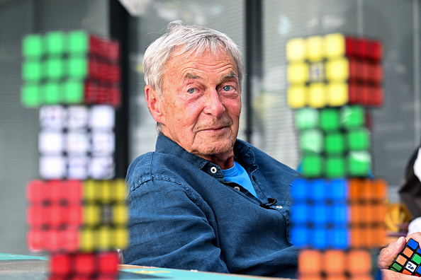 L'inventeur hongrois Erno Rubik est assis à côté de plusieurs Rubik's Cubes à Budapest, le 29 avril 2024. (ATTILA KISBENEDEK/AFP via Getty Images)