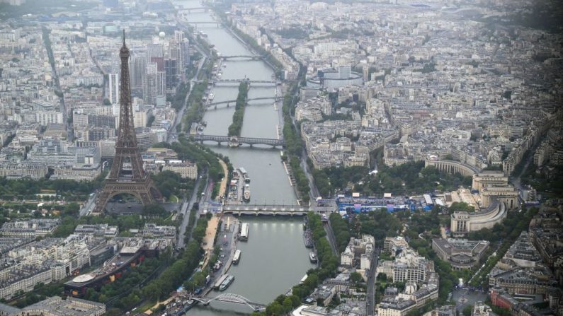 PARIS, FRANCE - JULY 26: A photograph taken from an helicopter on July 26, 2024 shows an aerial view of the Eiffel Tower along the Seine river during the opening ceremony of the Paris 2024 Olympic Games in Paris. (Photo Lionel Bonaventure Pool/Getty Images)