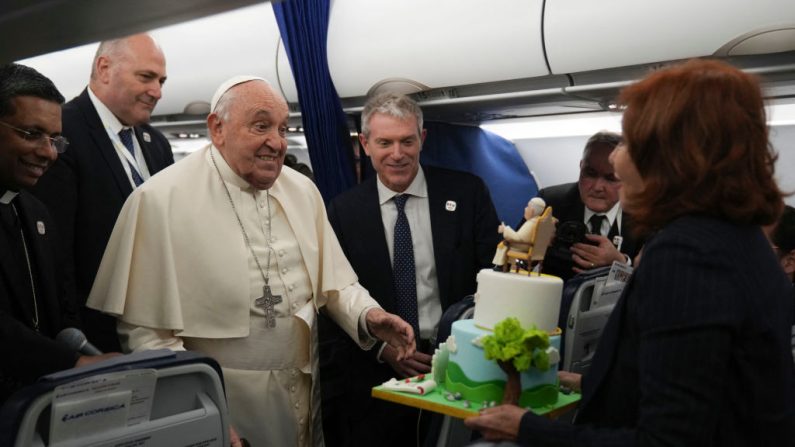 Un gâteau d'anniversaire est offert au pape François dans l'avion qui le ramène à Rome à l'issue de sa visite d'un jour à Ajaccio, le 15 décembre 2024. (Photo : ALESSANDRA TARANTINO/POOL/AFP via Getty Images)