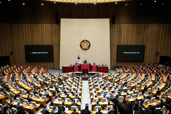 Les législateurs sud-coréens lors d'une session plénière du vote de destitution du Président Yoon Suk Yeol à l'Assemblée nationale à Séoul en Corée du Sud, le 14 décembre 2024. (Woohae Cho/Getty Images)