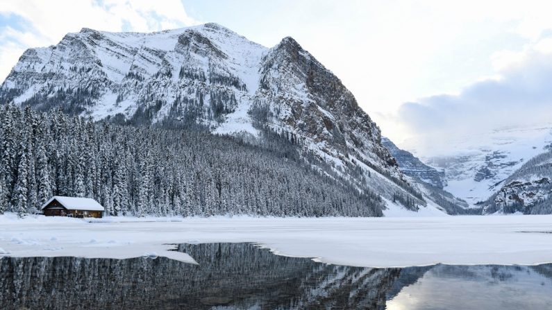 Une montagne enneigée se reflète dans le lac Louise avant une tempête hivernale dans le parc national de Banff, Alberta, Canada, le 29 novembre 2021. (PATRICK T. FALLON/AFP via Getty Images)