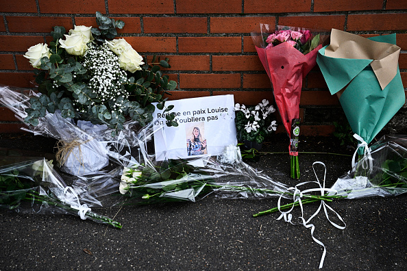 Des fleurs et une photo de Louise, une élève de onze ans décédée, placées devant le collège André Maurois d'Épinay-sur-Orge, le 8 février 2025.  (Crédit photo JULIEN DE ROSA/AFP via Getty Images)