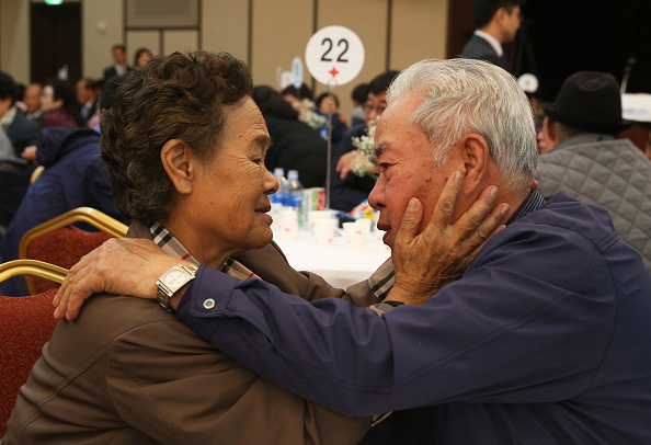 Lee Cheon-Woo, sud-coréen (D) pleure avec sa sœur nord-coréenne Ri Mun-Woo (G) alors qu'ils font leurs adieux après leur réunion de famille, le 22 octobre 2015 au Mont Kumgang, en Corée du Nord. Le programme permettait de réunir les membres de familles séparées par la guerre de Corée de 1950 à 1953. (l'Association des photographes de la presse coréenne via Getty Images)